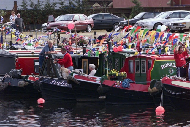 A couple look at the canal barges gathered at Clarence Dock ready to take part in the Lord Mayor's Parade.