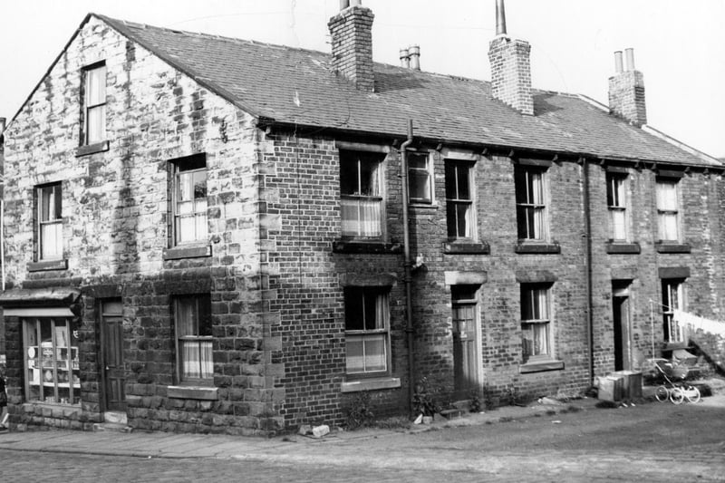 Great Northern Street of terraced houses pictured in July 1971. Shop on the corner is that of Doris Wilson, general store at 29 Fountain Street. A pram and a line of washing can be seen outside the far property on the unmade access road off the cobbled road of Great Northern Street.