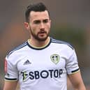 IMPRESSED: Leeds United star Jack Harrison with a new Whites addition. Photo by Gareth Copley/Getty Images.