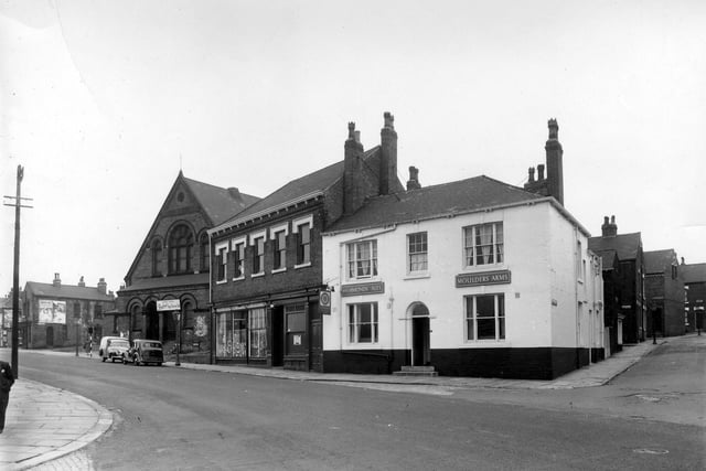 A view of the junction of Cherry Row with Lincoln Road in August 1958. This part of Burmantofts was also known as Newtown. At the very left edge is Lincoln Field Row, then, with advertising on the side of the end property, is Lincoln Street. The building with the arched doors and windows is the old Lincoln Fields Wesleyan Methodist Sunday School, at number 6 Hill Street, located at the junction with Cherry Row and Hill Street. It has a sign above the entrance advertising 'Empire House-Farmlands Egg Stores Ltd.' In the centre at numbers 12 & 14 are the premises of the Leeds Industrial Co-operative Society. The white building  on  Cherry Row, is the Moulders Arms pub. Lincoln Road is far right. Lincoln Road is visible at the extreme right edge.