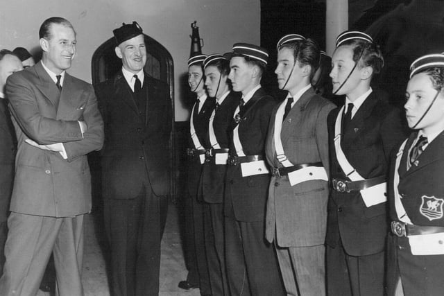 The Duke of Edinburgh chats with members of a drill squad formed by the 8th Leeds Company of the Boys Brigade at Burley Methodist Church in May 1958. He is pictured with company captain E. L. Peck.