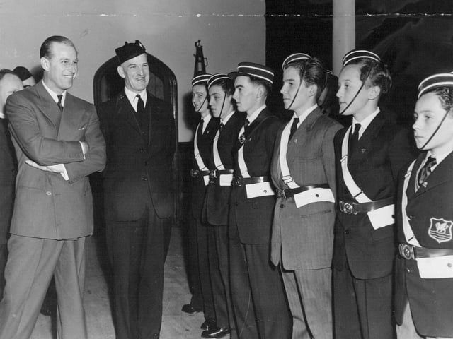 The Duke of Edinburgh chats with members of a drill squad formed by the 8th Leeds Company of the Boys Brigade at Burley Methodist Church in May 1958. He is pictured with company captain E. L. Peck.