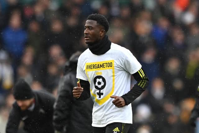 LEEDS, ENGLAND - FEBRUARY 20: Nohan Kenneh of Leeds United warms up whilst wearing a 'HerGameToo: Campaign Against Sexism In Football' t-shirt prior to the Premier League match between Leeds United and Manchester United at Elland Road on February 20, 2022 in Leeds, England. (Photo by Shaun Botterill/Getty Images)