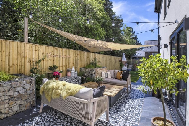 Dine al fresco or relax with a book in this comfortable outdoor space.