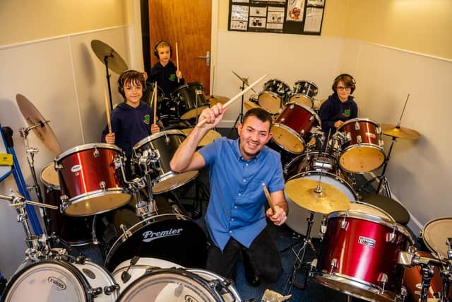 Drum teacher Nathan Haywood, celebrates the success with pupils. (Pic: James Hardisty)