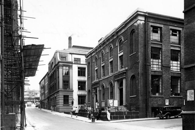Lady Lane at corner with Templar Lane in June 1956. The premises of Hoover Ltd. are visible next to Alexandre Ltd. tailors. Scaffolding on the left. Sharp and Thomas house furnishers visible on Vicar Lane in the background.