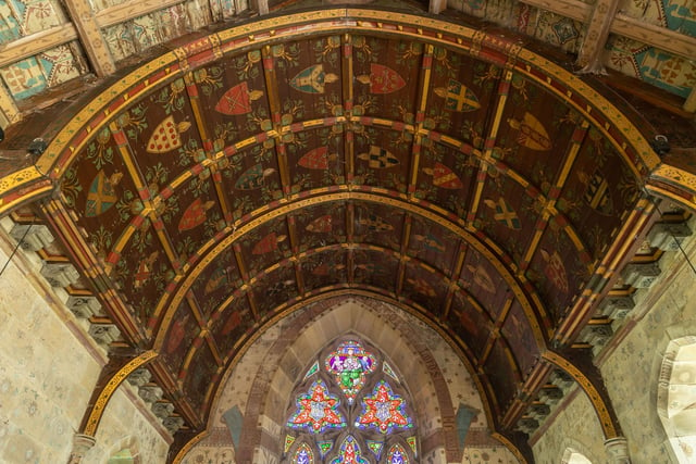 Detailed work on the ceiling of the church, and stained glass windows.