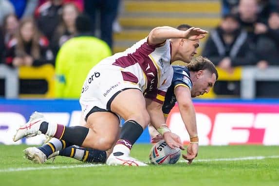 Cameron Smith scores for Rhinos in their win over Huddersfield at Easter. Picture by Allan McKenzie/SWpix.com.