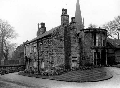 The head gardener's house at Burley Park with Burley Methodist Church in the background. Pictured in April 1952.