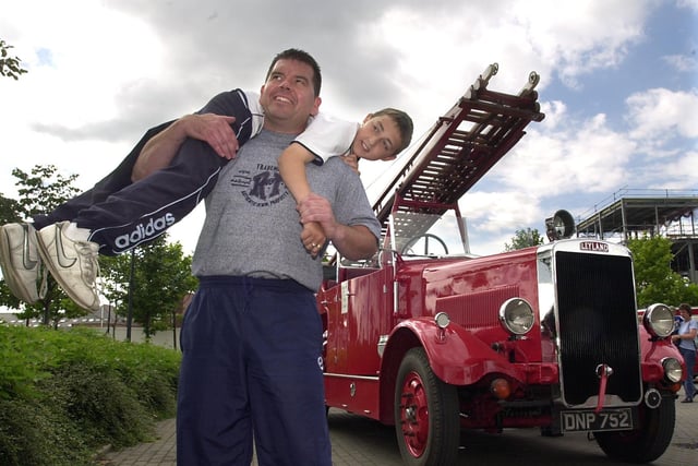 The Red Cross charity joined forces with emergency services to stage a  999 Awareness Day for members of the public at the Royal Armouries Museum. Pictured is firefighter Jonathan Hunter giving  visitor Chris Morton a fireman's lift.