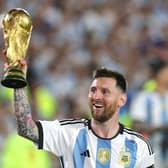 BUENOS AIRES, ARGENTINA - MARCH 23:  Lionel Messi of Argentina lifts the FIFA World Cup trophy during the World Champions' celebrations after an international friendly match between Argentina and Panama at Estadio Más Monumental Antonio Vespucio Liberti on March 23, 2023 in Buenos Aires, Argentina. (Photo by Daniel Jayo/Getty Images)