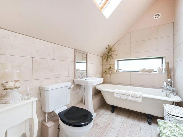 The family bathroom is a three-piece suite with a roll-top bath, wash hand basin and a low level WC.