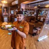 Tharavadu, Mill Hill, Leeds, which serves Keralan cuisine. Pictured: Waiter Abijith Ajith, holding dish Tharavadu Sadya.