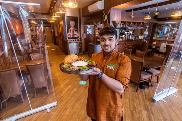 Tharavadu, Mill Hill, Leeds, which serves Keralan cuisine. Pictured: Waiter Abijith Ajith, holding dish Tharavadu Sadya.
