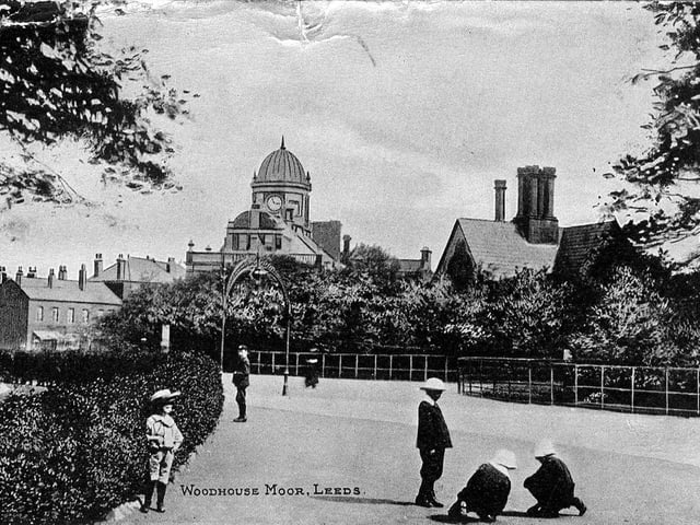 Postcard with a postmark of June 12, 1908 showing Woodhouse Moor looking towards the building housing the police and fire stations and the library on Woodhouse Lane which opened in 1902. Children are seen playing in the foreground.