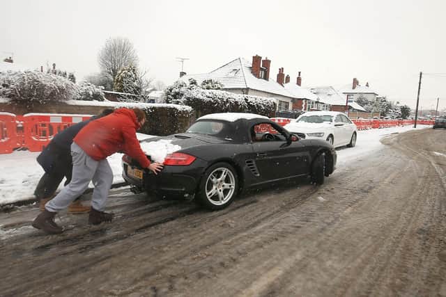 A car is pushed on icy roads in Leeds. Photo: PA