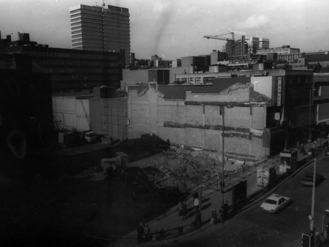 March 1982 after the 1960s Saxone building, at junction of Boar Lane with Briggate, had just been demolished. The 19th century building that originally stood on this site, at the junction of Boar Lane and Briggate, (right) had housed Pullan's Central Shawl and Mantle Warehouse, then Sutton's Mantle shop before Saxone's shoe shop took over circa 1908.