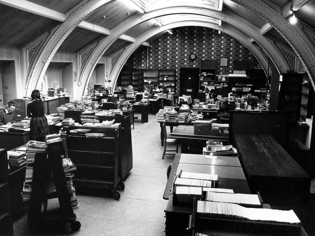 The cataloguing department located in the third floor office of Leeds Central Library. Staff, pictured in April 1984, are at work processing new stock for allocation to branches, Central and the Reference Library.