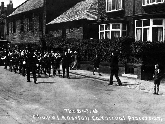 Chapel Allerton Carnival procession in June 1930. In front of the band is a policeman a decorated car is behind.