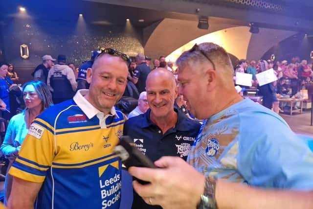Leeds Rhinos coach Brad Arthur poses for a picture with two supporters at a meet the fans event in Las Vegas. Picture by Peter Smith.