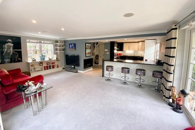 The contemporary style open plan interior with the kitchen to the rear.