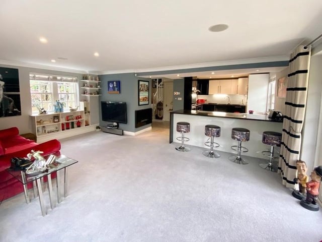The contemporary style open plan interior with the kitchen to the rear.