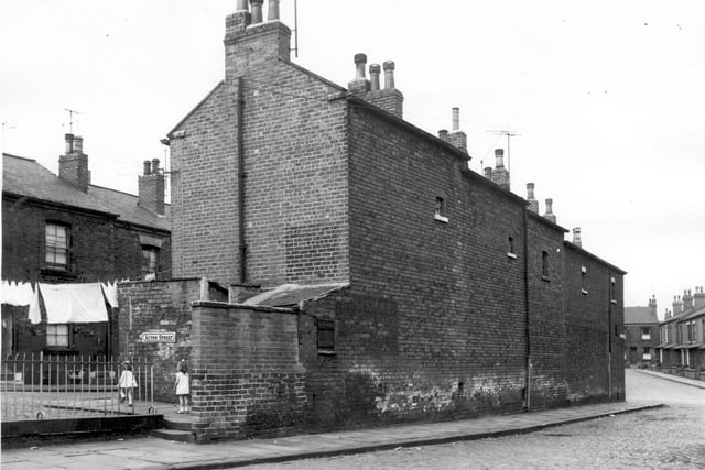 These houses on Maitland Place at the junction with Acton Street have small windows at the rear at upper floor level. The front on to Brixton Place and are numbered from left to right 2 to 10. The one storey brick buildings to the left are outside toilet facilities and there are railings to the left probably for child safety reasons as the school is within the vicinity.