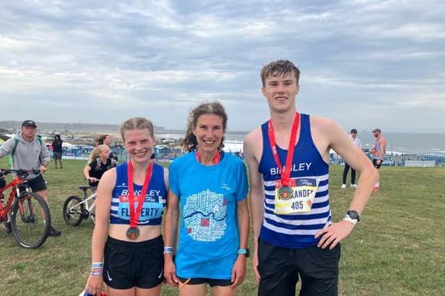 Rebecca Flaherty with her mum Sarah and brother Alex after setting a new Guinness World Record for the fastest mother-and-daughter half marathon at the Great North Run.
