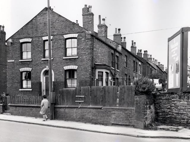 Number 200 Tong Road, a gable end property which was also known as Hope Cottage. Number 200 Tong Road was also number 1 Parsonage View which continues in ascending order to the right. Parsonage View had no access from Tong Road and was reached via passageways from Main Street. Billboards can be seen on the right edge. Included in slum clearance plans for the Armley area. Pictured in August 1966.