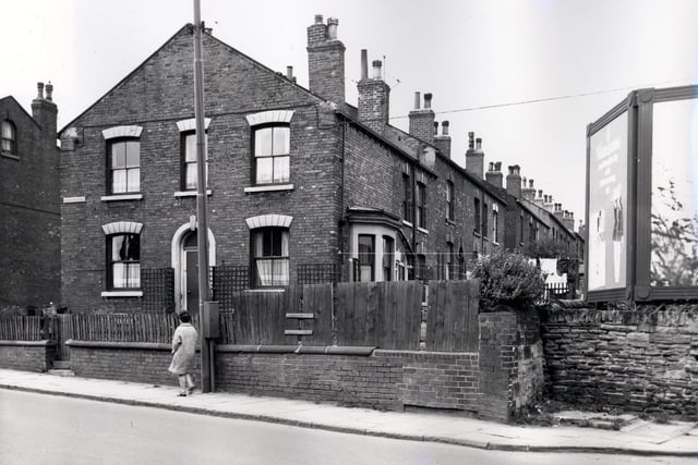 Number 200 Tong Road, a gable end property which was also known as Hope Cottage. Number 200 Tong Road was also number 1 Parsonage View which continues in ascending order to the right. Parsonage View had no access from Tong Road and was reached via passageways from Main Street. Billboards can be seen on the right edge. Included in slum clearance plans for the Armley area. Pictured in August 1966.
