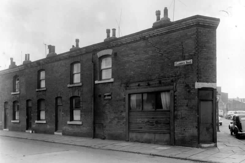 Clarence Road in August 1961. The shop on the junction appears to be boarded up and the sign above the window has been removed. Cars are parked on Albury Road. This area was part of a clearance scheme according to the Housing Act of 1957.