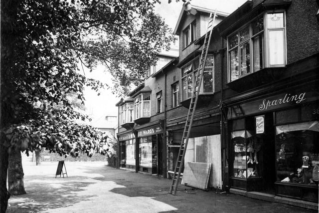 Moortown Parade on Harrogate Road pictured in June 1935. On the left is Allerton Grove, then moving to the right number 392a Hairdresser, next 392 Arthur Ward pork butcher, 390 is being fitted out as a branch of Barclays Bank, 388 premises of Winifred Sparling, outfitters. A notice above the door states that the shop stocks items in the colours for Roundhay School Uniform.