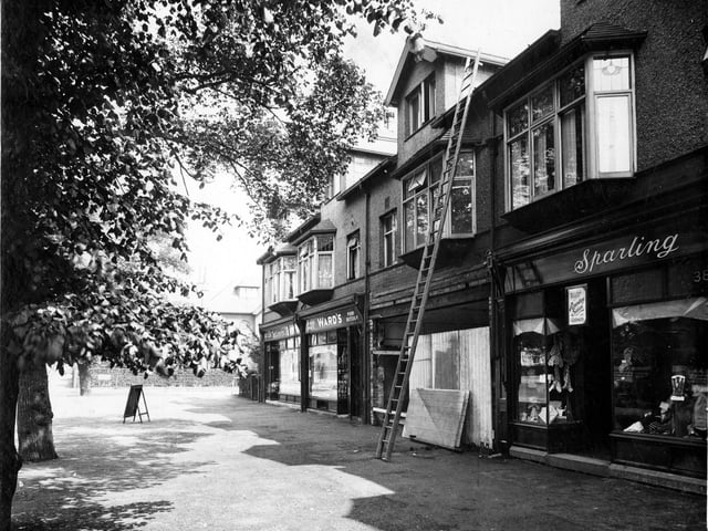 Moortown Parade on Harrogate Road pictured in June 1935. On the left is Allerton Grove, then moving to the right number 392a Hairdresser, next 392 Arthur Ward pork butcher, 390 is being fitted out as a branch of Barclays Bank, 388 premises of Winifred Sparling, outfitters. A notice above the door states that the shop stocks items in the colours for Roundhay School Uniform.