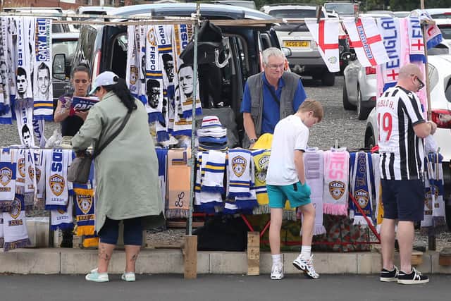 LEEDS, ENGLAND - JULY 31: A vendor sells Leeds United scarves during the Pre-Season friendly match between Leeds United and Cagliari at Elland Road on July 31, 2022 in Leeds, England. (Photo by Ashley Allen/Getty Images)