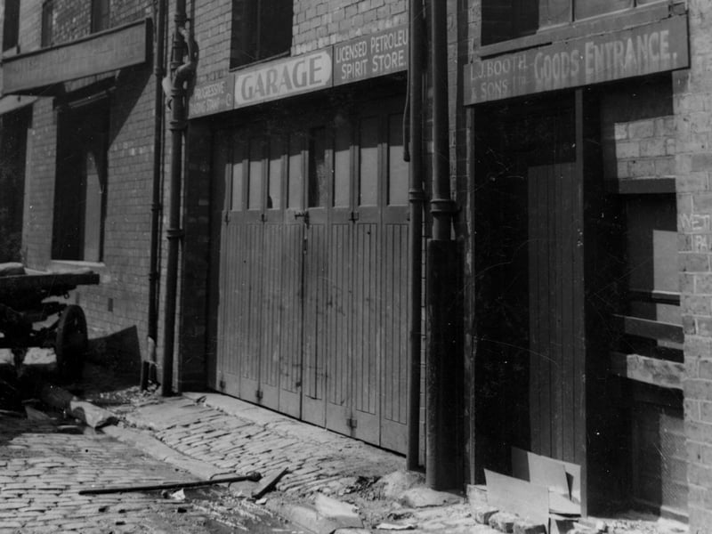 Back York Place in July 1936. This photograph shows the backs of several business premises including a garage petrol store and the goods entrance of L.J. Booth & Son.