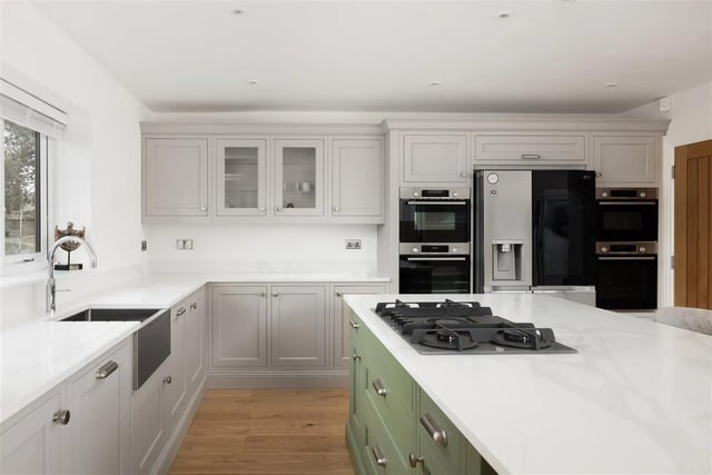 The bespoke German kitchen is packed with high specification features with double Bosch Ovens and microwave grills, an LG touch screen large fridge/freezer and breakfast bar, all of which is complimented by quartz worktops throughout.