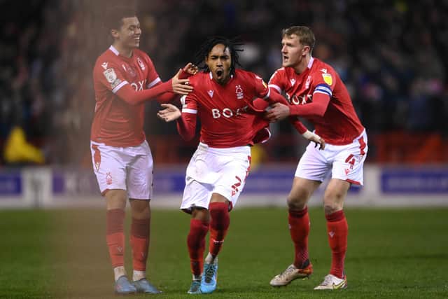 'UNBELIEVABLY EFFECTIVE': Leeds United new boy Djed Spence, centre, with Brennan Johnson, left, at former loan club Nottingham Forest, the pair pictured with Joe Worrall, right, after Spence's strike in the Championship clash against Queens Park Rangers at the City Ground of March 2022. Photo by Laurence Griffiths/Getty Images.