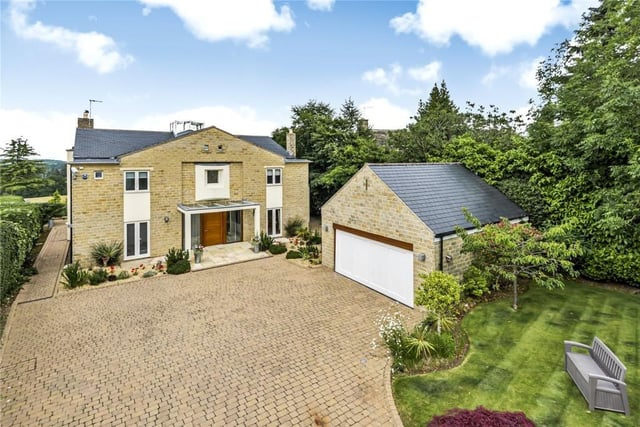 This wonderful four bedroom house was designed by the current owners and built to an exceptionally high standard throughout, with the added advantage of panoramic views of Eccup Reservoir. Located on Lakeland Drive in Alwoodley, an electric gated entrance reveals spacious living accommodation extending to approximately 3810 sq. ft.