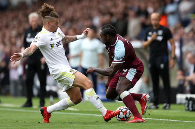 LEEDS, ENGLAND - SEPTEMBER 25: Michail Antonio of West Ham United battles for possession with Kalvin Phillips of Leeds United during the Premier League match between Leeds United and West Ham United at Elland Road on September 25, 2021 in Leeds, England. (Photo by George Wood/Getty Images)