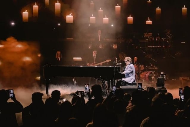 The elaborate stage design included a large screen fixed around an ornate mirror frame and a roaming piano at which Sir Elton sat