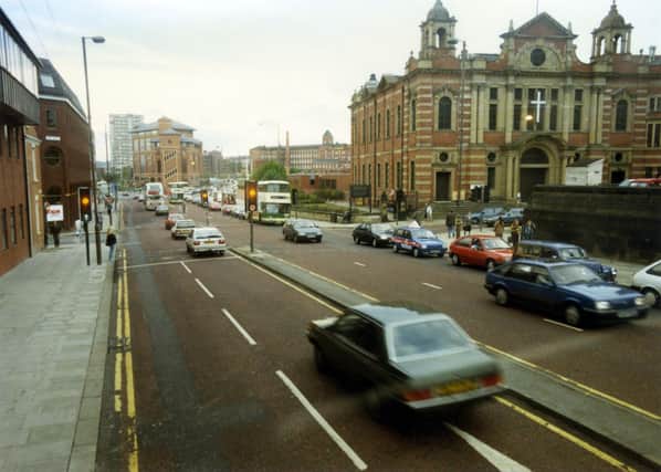 Looking west along The Headrow, towards Westgate, which begins after the junction with Oxford Place, located in front of Oxford Place Chapel which dominates the right-hand side of the image. This is now known as the Oxford Place Methodist Centre. To the left of it, between the junctions of Oxford Row and Park Street is Leeds Combined Court Centre. The red brick building with large glass windows at the junction with Park Street and Park Lane is the Magistrates Court. Behind it the 1966 high rise residential block, Marlborough Towers is visible.