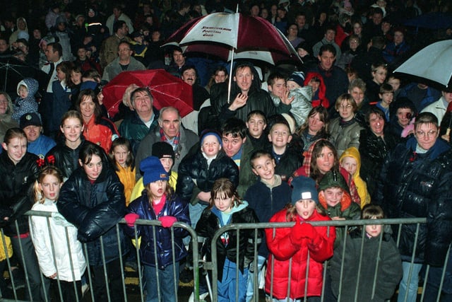 People brave the rain as they wait for Leeds United footballer Alan Smith to switch on the Christmas lights in November 2000.