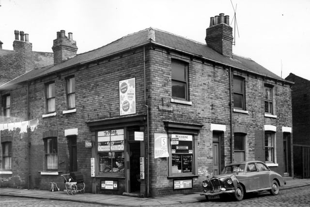 April 964 and to the left is Cariss Street. The shop is a greengrocers with a window onto Milner Grove.