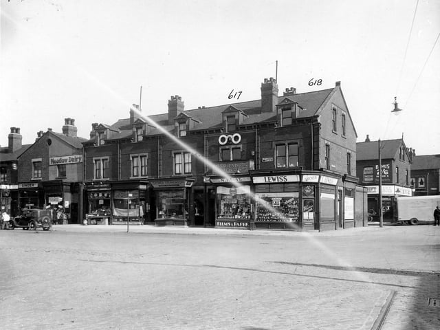 Harehills Lane in September 1935. In focus are number 355 Singer Sewing Machine Co. Ltd. Number 357 Meadow Dairy Co. Ltd. Number 359 Hartley, Wm Thomas Greengrocer, Hartleys Fruit market, number 361 Woodhead, Eric Confectioner, number 363 Stephenson, George butcher, number 365 Hirst, Norman chemist, Number 367 Lewis's shoeshop Foundry Lane now called Foundry Approach