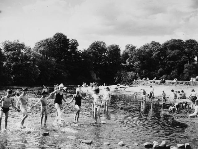 Children play in the rover at Bolton Abbey in August 1960.