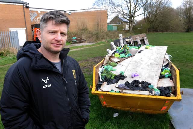 Carl Thewlis, Chairman of Moortown Rugby Club by the skip at the back of the rugby club loaded with dog poo bags. Photo: Steve Riding