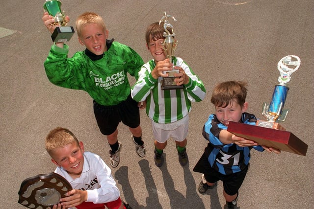 Members of the four triumphant football teams at Clapgate Primary School in Belle Isle in July 1996. Pictured, from left, are  Scott Murgatroyd (U-8s), Dane Waugh (U-11s), Karl Featherstone (U-9s) and Danny Needham (U-10s).