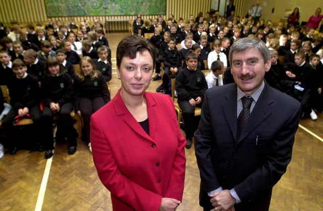 Pupils at Crawshaw High School, Pudsey, Leeds, returned on September 6, 2001 for the first time after the school was badly-damaged by the fire. Pictured left, Tracey Coy, head of year and Nigel Turner, headteacher, with Year 7 pupils looking on.