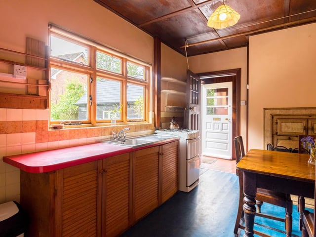 Towards the back of the hall is the kitchen, the heart of the home, and having stood the test of time, has cupboards, nooks and crannies which are fine examples of bespoke joinery.