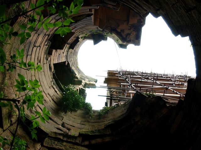 Looking up one of the towers of Harewood Castle, a 14th-century stone hall house and courtyard fortress, located on the Harewood estate.